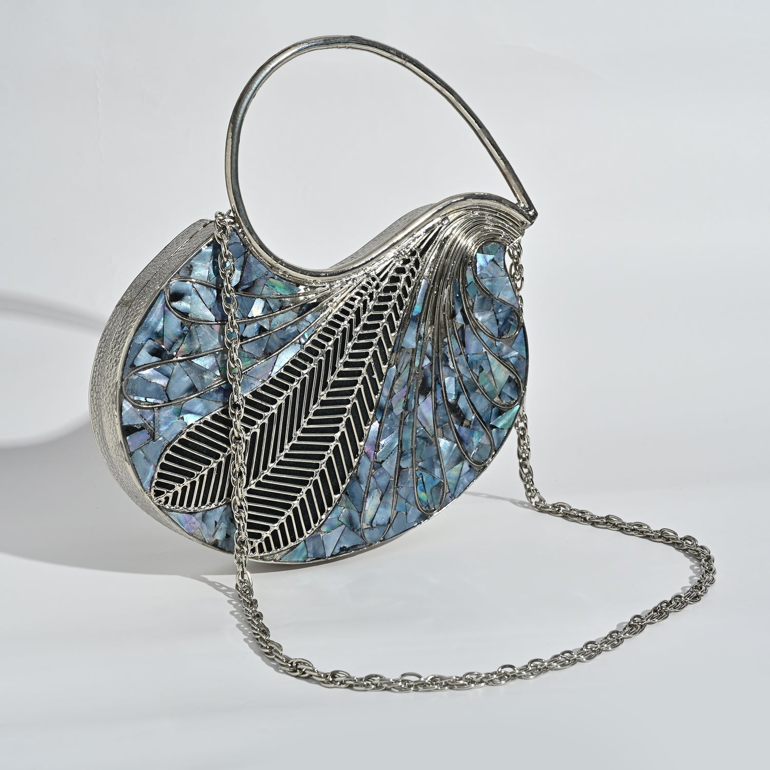 Handbag with feather design and mosaic pattern on a light background